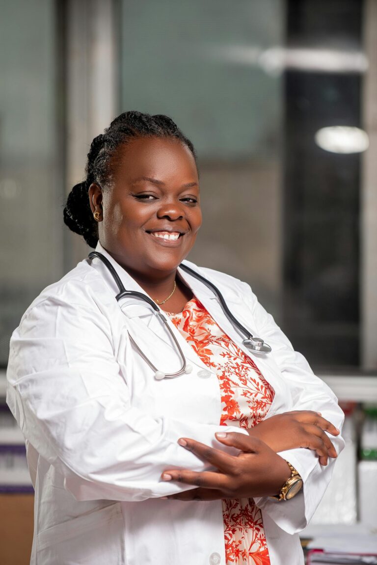 Confident African medical professional smiling in clinic, representing healthcare in Kinshasa.